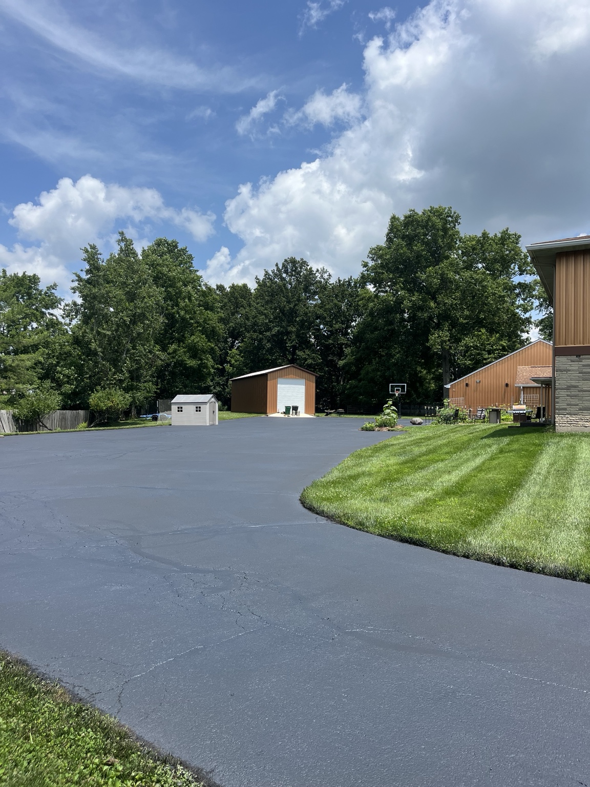 Large freshly sealed residential asphalt driveway